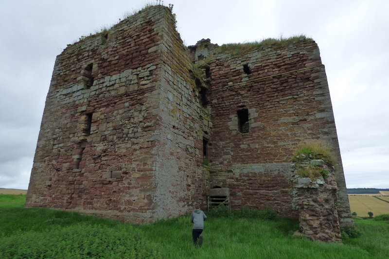 Approaching the entrance to Cessford Castle which is behind a crude wooden gate.