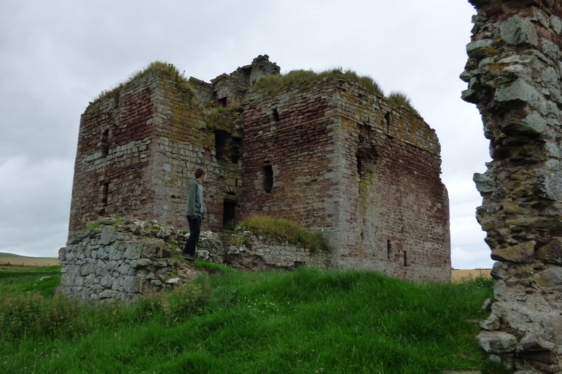 Ruins of Cessford Castle with remains of outer walll in foreground