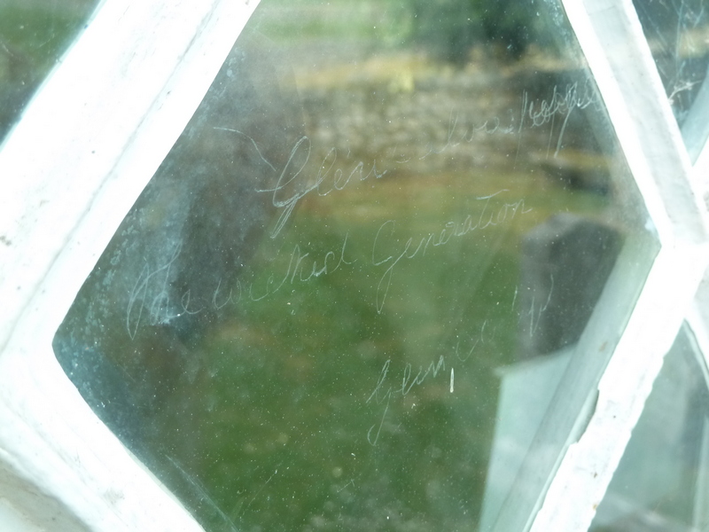 Writing etched onto glass window of Croick Church