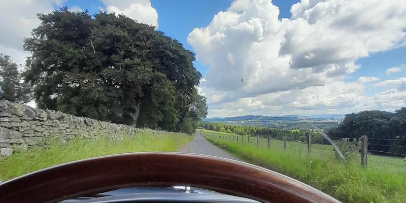 Car driving on back roads in the Scottish Borders