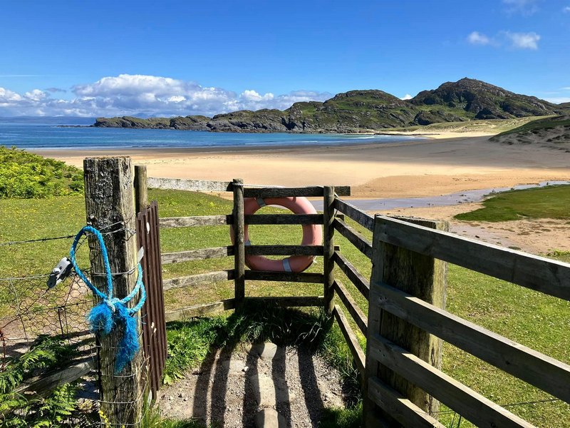 Gate leading down to the beach at Kiloran Bay in Scotland 