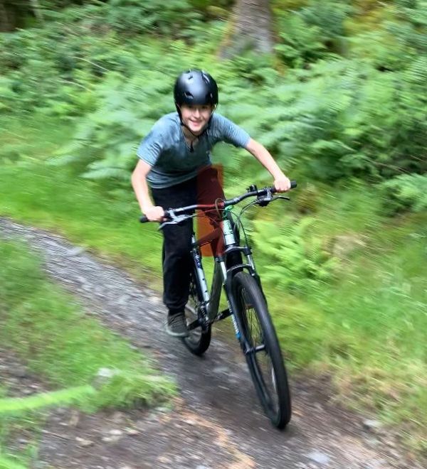 Teenage boy having fun on Mountain Bike at Kirroughtree Forest