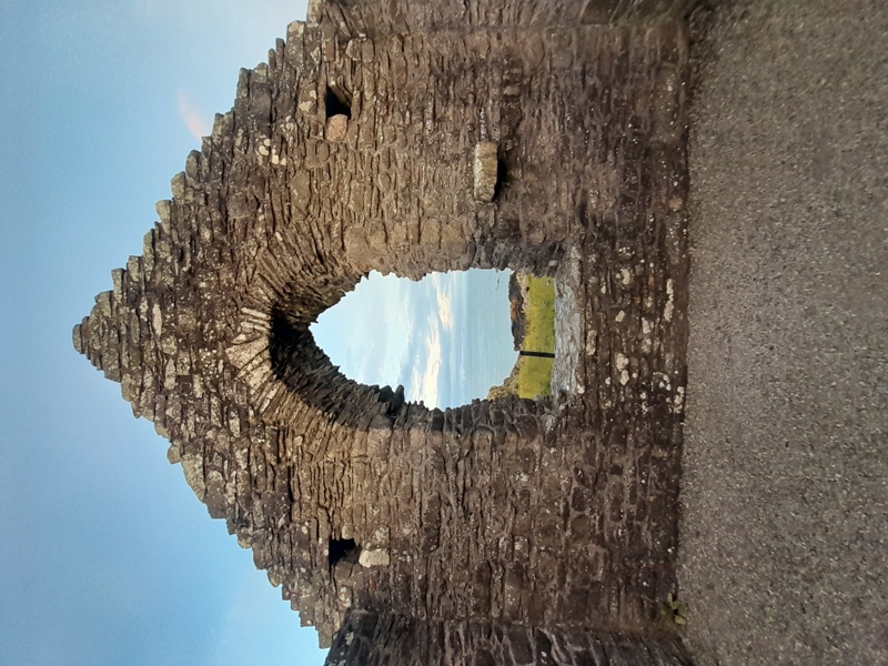 Inside St Ninian's Chapel looking through window out to Irish sea.